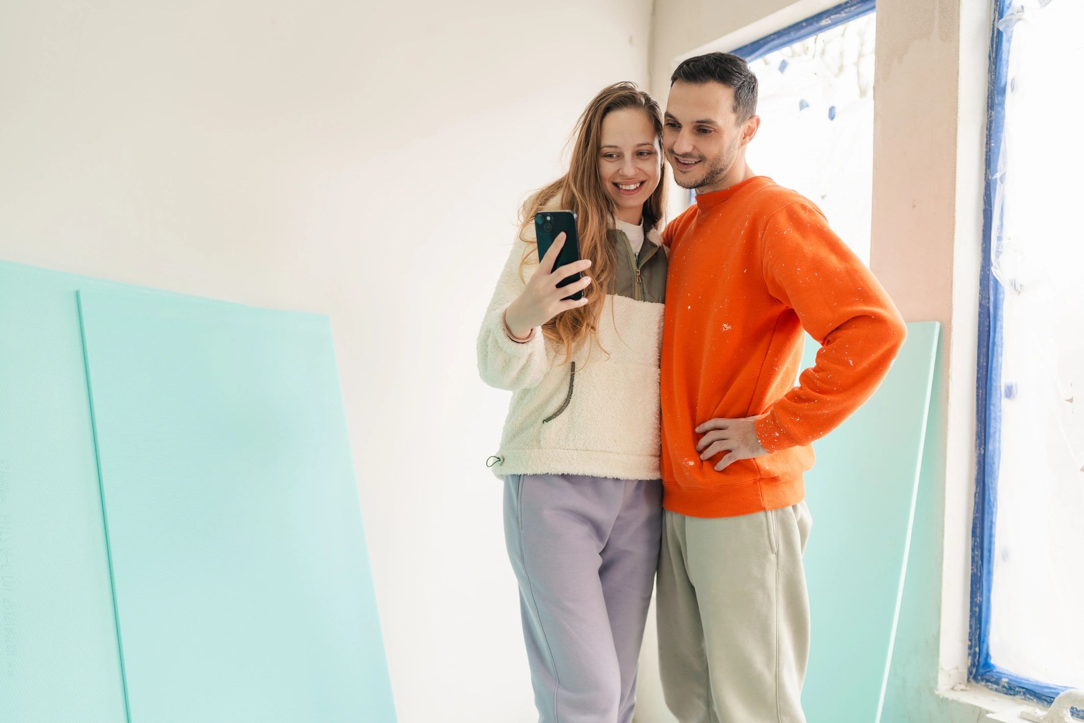 Homeowners reviewing renovation plans on a smartphone